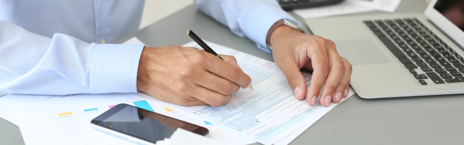 person writing on papers