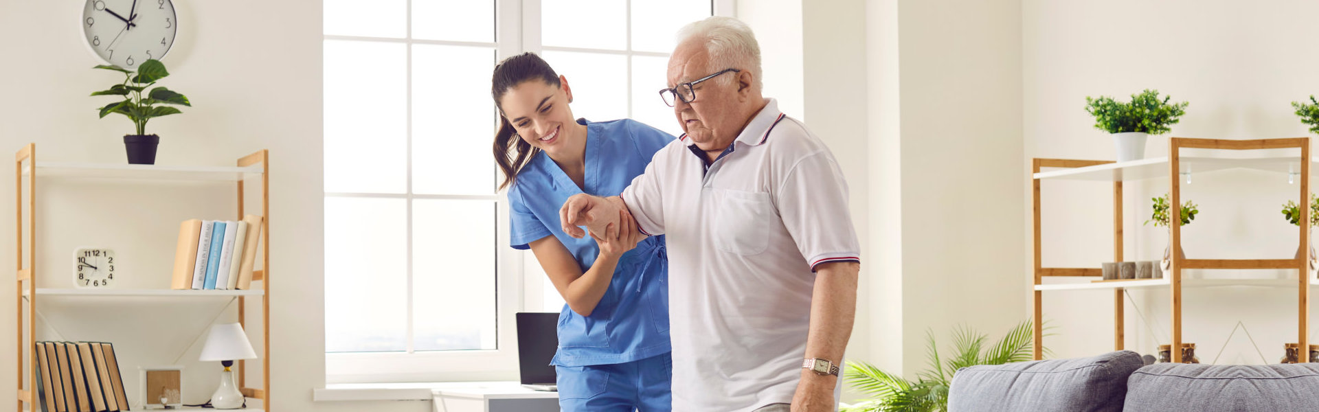 woman helps an elderly man to walk